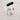 A set of 10 false press-on nails displayed on a clear plastic tray, featuring various pastel designs including blue waves, pink snowflakes, and purple gradients, with a black tape strip above the tray on a textured gray background.